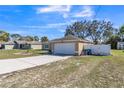 Inviting single-story home with an attached garage, a spacious driveway and minimal landscaping at 10352 Lansfield St, Spring Hill, FL 34608