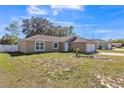 Beautiful single-story home with an attached garage, well-manicured front lawn, and welcoming curb appeal at 10352 Lansfield St, Spring Hill, FL 34608