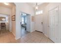 Inviting foyer features tile flooring, high ceilings, and a view into the living room at 129 Treviso Ct, North Venice, FL 34275