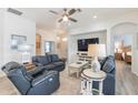 Bright living room with comfortable seating, ceiling fan, and views of the foyer and bedroom at 129 Treviso Ct, North Venice, FL 34275