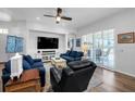 Open living room with neutral colors, hardwood flooring, large window, and modern furniture at 129 Treviso Ct, North Venice, FL 34275
