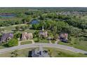 Aerial view of a home near a lake, golf course and other homes at 13551 Carnoustie Cir, Dade City, FL 33525