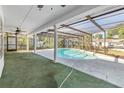 Inviting screened-in pool with a covered patio, perfect for outdoor relaxation and entertaining at 13982 Whisperwood Dr, Clearwater, FL 33762
