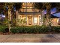Charming two-story home with a welcoming porch, columns, manicured landscaping, and a two-car garage at 14123 Barrington Stowers Dr, Lithia, FL 33547