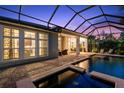 Inviting screened-in pool with outdoor seating, lush landscaping, and a relaxing spa at 14123 Barrington Stowers Dr, Lithia, FL 33547