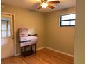 Bedroom with hardwood floors, a ceiling fan, and a window at 1706 E Fern St, Tampa, FL 33610