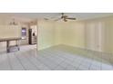 Bright and airy living room featuring neutral walls, tile flooring, and a ceiling fan at 2035 Ronald Cir, Seffner, FL 33584