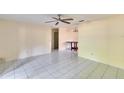 Inviting living room with tile flooring, neutral tones, and a view into the adjacent dining area at 2035 Ronald Cir, Seffner, FL 33584