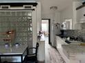 Bright kitchen with white cabinets, marble countertops, and modern appliances at 20861 Haulover Cv # 5, Lutz, FL 33558