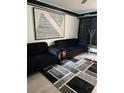 Modern living room featuring sleek black sofas, geometric art, and stylish decor at 20861 Haulover Cv # 5, Lutz, FL 33558