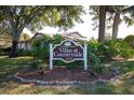 Villas at Countryside community sign surrounded by mature trees and lush landscaping at 2440 Enterprise Rd # 2, Clearwater, FL 33763