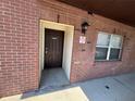 The building entrance shows a new door and window and well-maintained brick facade at 2440 Enterprise Rd # 2, Clearwater, FL 33763