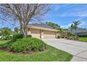 Spacious three-car garage and large driveway, perfect for car enthusiasts or ample parking at 2905 Hillside Ramble Dr, Brandon, FL 33511