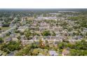 Aerial neighborhood view with a red location pin indicating the property, set amongst a tree-filled community at 3276 Morven Dr, Spring Hill, FL 34609