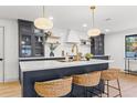 Stylish kitchen island featuring a white countertop, gold faucet, and woven barstools at 398 Walnut Ct, Palm Harbor, FL 34683
