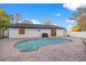 Beautiful kidney-shaped pool surrounded by brick pavers, perfect for outdoor entertaining at 398 Walnut Ct, Palm Harbor, FL 34683