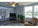 Bright living room offering scenic pond views with neutral paint, a ceiling fan and comfortable seating at 4338 Tahitian Gardens Cir # H, Holiday, FL 34691