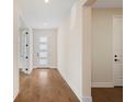 Bright hallway with hardwood floors and white doors providing a clean, modern aesthetic at 4405 W Euclid Ave, Tampa, FL 33629