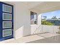 Home front porch with a modern blue door, white walls and railing, and an exterior view at 4405 W Euclid Ave, Tampa, FL 33629