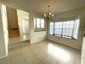 Bright dining area featuring tile floors, a bay window with a window seat, and a chandelier at 5014 Sterling Manor Dr, Tampa, FL 33647