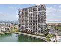 High-rise condo building with numerous private balconies overlooking the canal and surrounding community at 7300 Sun Island S Dr # 1705, South Pasadena, FL 33707