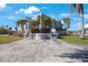 Beautiful home with an expansive driveway, manicured lawn, and lush landscaping at 816 Ponce De Leon Dr, Tierra Verde, FL 33715