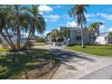Stunning waterfront home boasting mature palms, a circular drive, and charming curb appeal at 816 Ponce De Leon Dr, Tierra Verde, FL 33715