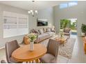 Bright living room with large windows, light gray walls, and contemporary furnishings at 8314 Deerland Bluff Ln, Riverview, FL 33578