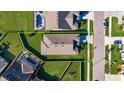 An aerial shot shows property lines highlighting location with manicured lawns in a residential neighborhood at 9748 Ibis Grove Blvd, Wesley Chapel, FL 33545