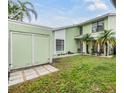 Two-story home features a well-manicured lawn, attached garage, and a walkway to the front door at 10306 Green Grove Pl, Tampa, FL 33624