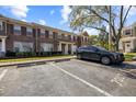 Townhome featuring designated parking, well-maintained lawn, and lovely landscaping at 11047 Black Swan Ct, Seffner, FL 33584