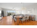 Bright living and dining area with wood floors, balcony, and elegant decor at 1200 Country Club Drive Dr # 3303, Largo, FL 33771