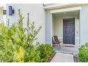 Inviting front porch with seating area and lush landscaping adding curb appeal at 16051 Weathered Windmill Ter, Odessa, FL 33556