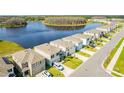 Rows of houses in a neighborhood near a lake offer scenic views and a Gathering-friendly atmosphere at 16051 Weathered Windmill Ter, Odessa, FL 33556