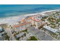 Coastal neighborhood with homes near a sandy beach, turquoise waters, and beautiful blue skies at 19 Somerset St, Clearwater Beach, FL 33767