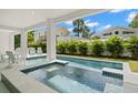 Inviting private pool with a clear, refreshing design surrounded by greenery at 19 Somerset St, Clearwater Beach, FL 33767