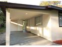 Attached carport offering shade and protection, seamlessly integrated with the home's design at 19455 Fort Dade Ave, Brooksville, FL 34601