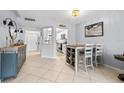 Open-concept dining room featuring tile flooring, light blue walls, and access to the kitchen and living room at 1986 Pelican Landing Blvd # 1514, Clearwater, FL 33762