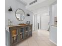 Light and bright foyer featuring tile floors, decorative lighting, a large mirror and a glass front console at 1986 Pelican Landing Blvd # 1514, Clearwater, FL 33762