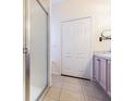Bathroom with tiled floor, shower stall, double-door closet, and neutral color scheme at 2514 Sandy Hill Ct, Holiday, FL 34691