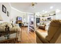 Open-concept living room with hardwood floors and seamless flow into the kitchen area at 2514 Sandy Hill Ct, Holiday, FL 34691