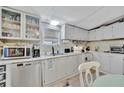 Bright kitchen features white cabinets, modern appliances, and ample counter space at 328 S Port Royal Ln, Apollo Beach, FL 33572
