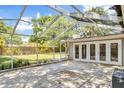 Paver-stone screened porch with access to the backyard through double doors, perfect for outdoor relaxation at 3609 S Omar Ave, Tampa, FL 33629