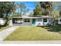 Well-maintained single-story home featuring a tidy front lawn and a screened-in porch at 4421 W Iowa Ave, Tampa, FL 33616