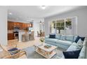 Bright living space with comfortable blue sectional and an open floorplan to the kitchen at 4515 Fieldview Cir, Wesley Chapel, FL 33545