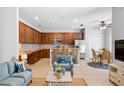 Open-concept living room and kitchen area, featuring a blue sectional and a central island at 4515 Fieldview Cir, Wesley Chapel, FL 33545