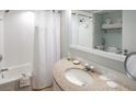 Bathroom featuring a shower/tub combination, a vanity with a granite countertop, and ample lighting at 5500 Gulf Blvd # 2228, St Pete Beach, FL 33706