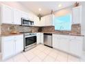 Well-equipped kitchen with stainless steel appliances, tile backsplash and ample cabinet space at 5702 War Admiral Dr, Wesley Chapel, FL 33544