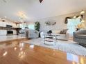 Bright living room featuring wood floors, modern furnishings, and an open floor plan at 5702 War Admiral Dr, Wesley Chapel, FL 33544