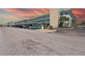 Exterior view of a multi-story condominium complex with carport parking and palm trees at 5935 30Th S Ave # 204, Gulfport, FL 33707